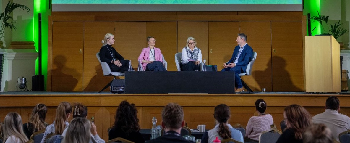 Aarron McGurk on a conference panel in front of an audience